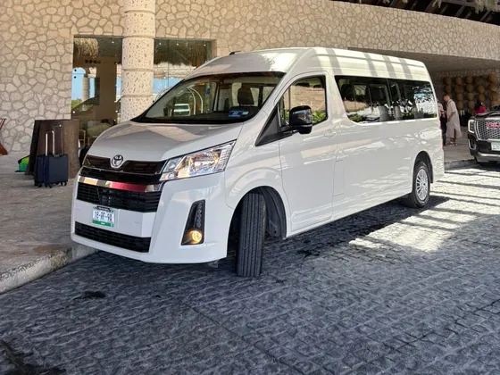 White Toyota Hiace van for a private transfer from Cancun Airport to Puerto Aventuras