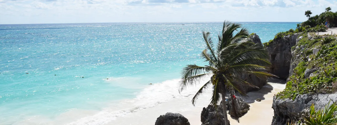 Turquoise water and white sand on the beach in Tulum